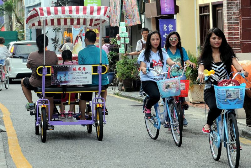 Tourists cycle along Armenian Street, situated within the core zone of the George Townu00e2u20acu2122s World Heritage Site, September 17, 2016. u00e2u20acu2022 Bernama pic