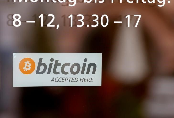 A sticker reading 'Bitcoin accepted here' displayed at the entrance of the Stadthaus town hall in Zug, Switzerland, August 30, 2016. u00e2u20acu201d Reuters pic