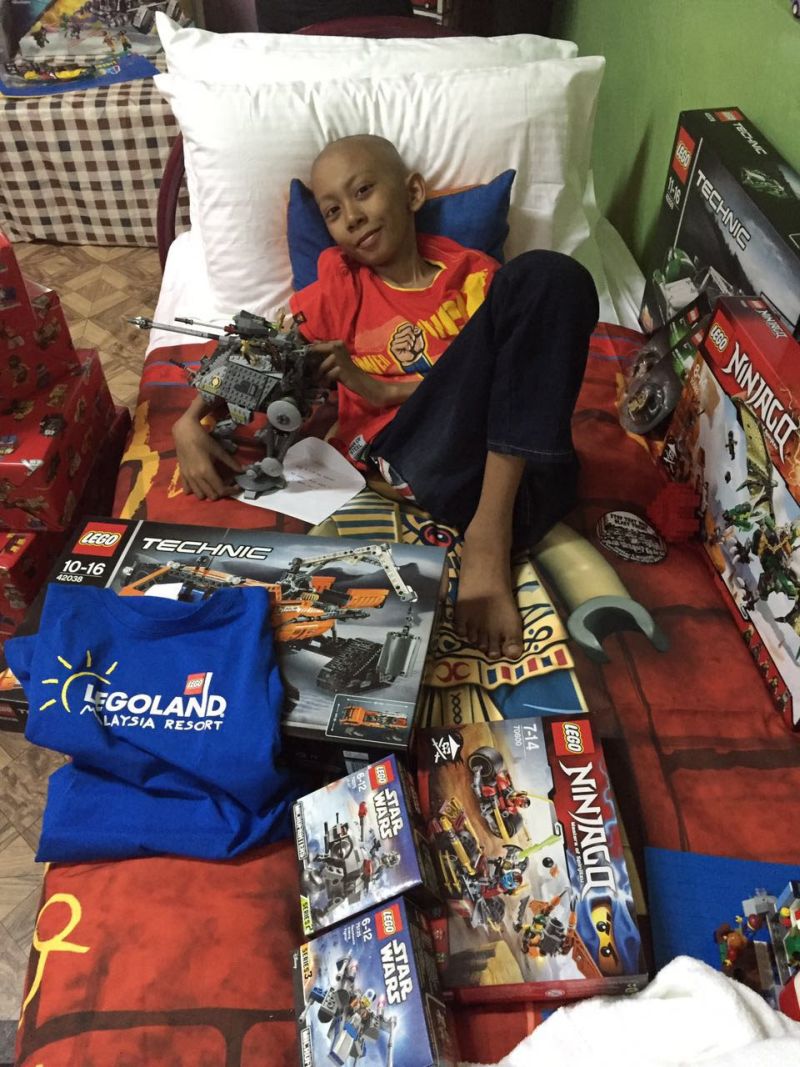 Danish, smiling, happy to receive LEGO toys and merchandises delivered to him.