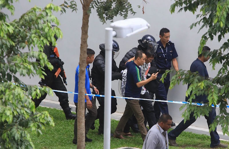Authorities escort a suspect in a hostage case on Sembawang Drive on Sept 27, 2016. u00e2u20acu201du00c2u00a0TODAY pic 