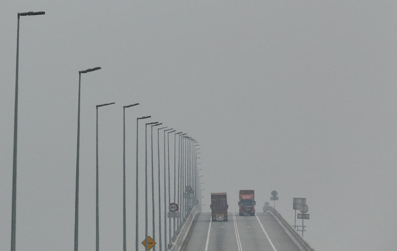 Lorries cross a bridge shrouded in haze in Klang, Malaysia, October 7, 2015. u00e2u20acu201d Reuters pic 