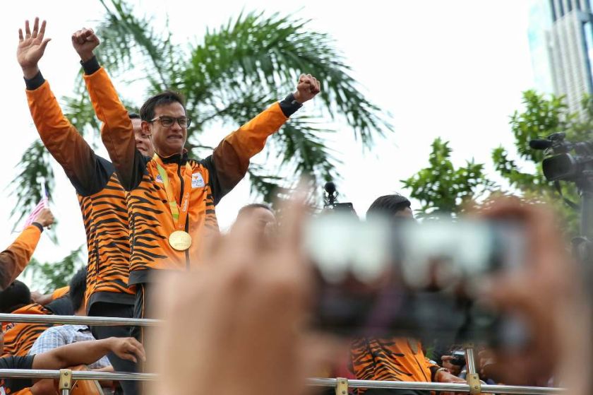 Malaysiau00e2u20acu2122s Paralympics athletes are pictured in an open-top bus parade as they arrive at KLCC on September 22, 2016. u00e2u20acu2022 Picture by Saw Siow Feng
