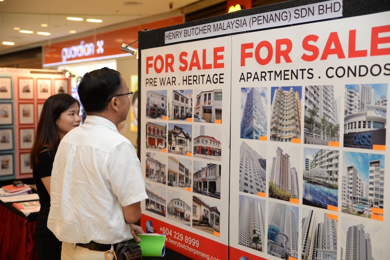 A visitor looks at a display depicting houses for sale at Maspex Penang in George Town September 23, 2016. u00e2u20acu201d Picture by KE Ooi