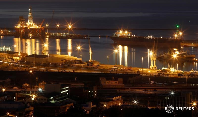 An oil rig lights up Cape Town harbour as the sun sets August 6, 2011. u00e2u20acu201d Reuters pic