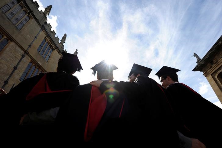 A group of graduates gather outside the Sheldonian Theatre to have their photograph taken after a graduation ceremony at Oxford University, Oxford, England, May 28, 2011. u00e2u20acu201d Reuters pic 