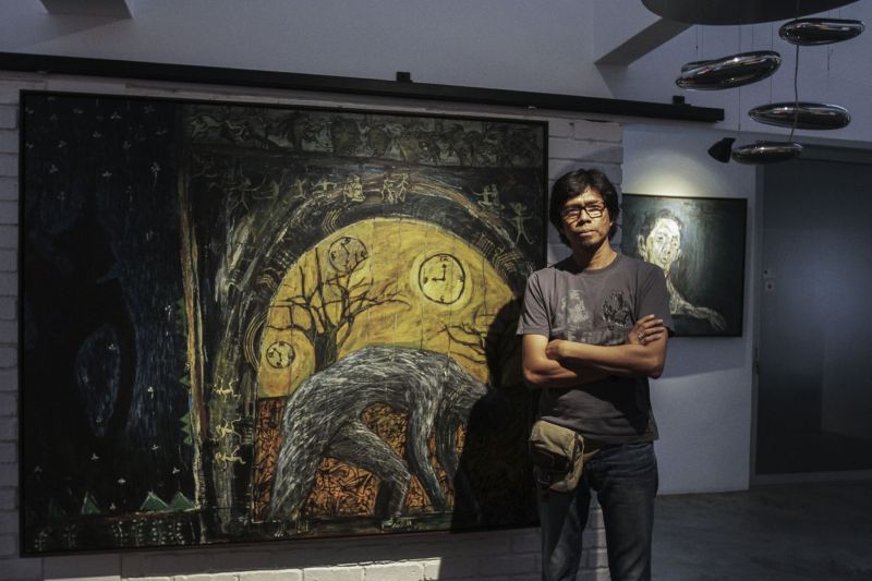 Artist Masnoor Ramli Mahmud stands in front of one of his paintings titled 'Once Upon A Time' at the Core Design Gallery in Subang Jaya, September 13, 2016. u00e2u20acu2022 Picture by Yusof Mat Isa