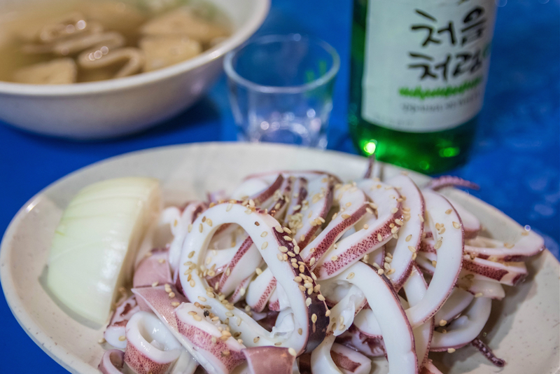 Steamed squid, with a bottle of soju and a bowl of odeng — fish cake — soup behind it, at Eun Joo Hee soju tent. — Reuters pic