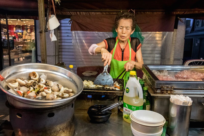 Kim Il-sun prepares dalkgalbe — spicy chicken with vegetables, stir-fried in soju — at Auntie's Soju Tent. — Reuters pic