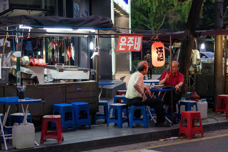 Two customers enjoy a summer night at a soju tent. u00e2u20acu201d Reuters pic