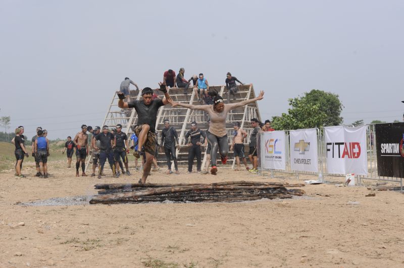 Participants crossing the finishing line at a Spartan race together. ― Picture courtesy of Reebok Spartan Race Malaysia