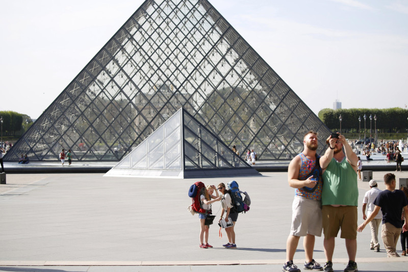 Tourists and visitors stand in front of the Louvre Pyramid designed by Chinese-born US Architect Ieoh Ming Pei in Paris, France, September 13, 2016. u00e2u20acu201d Reuters pic
