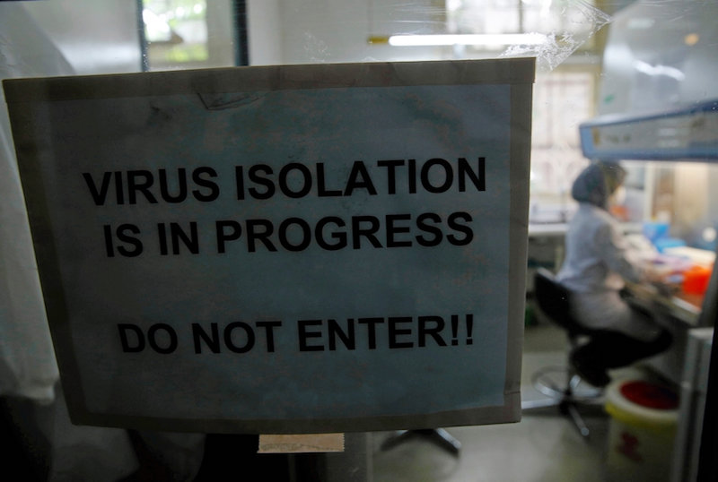 A sign is seen on the door of a laboratory as a lab technician prepares a medium to grow a virus at the Eijkman Institute in Jakarta, Indonesia August 31, 2016. u00e2u20acu201d Reuters pic