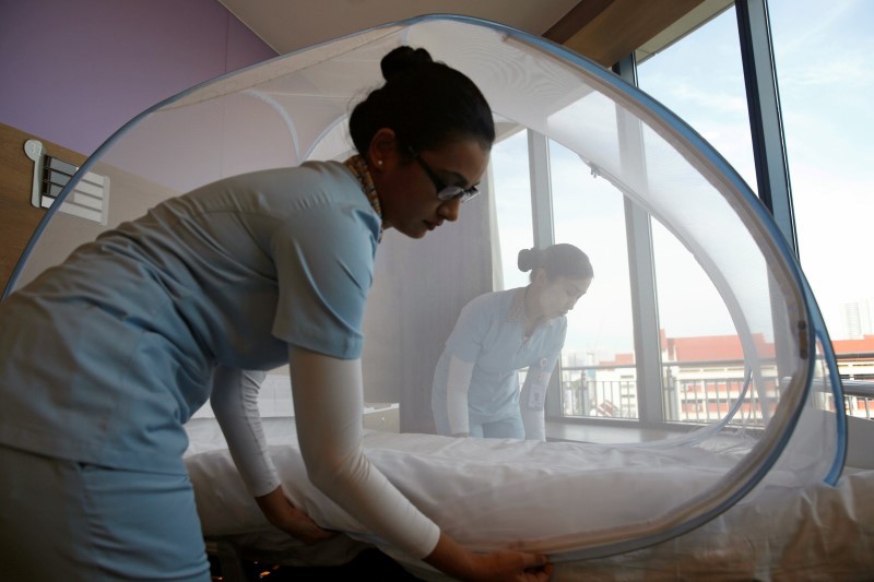 Nurses set up a mosquito tent over a hospital bed, as part of a precautionary protocol for patients who are infected by Zika, to show the media at Farrer Park Hospital in Singapore September 2, 2016. u00e2u20acu201d Reuters pic