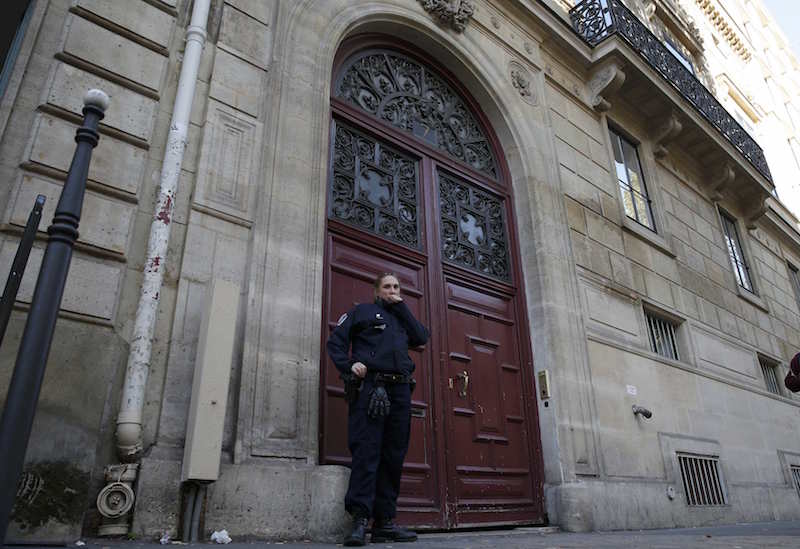 A police officer stands guard at the entrance of a luxury residence on the Rue Tronchet in central Paris October 3, 2016 where masked men robbed US reality TV star Kim Kardashian West at gunpoint.