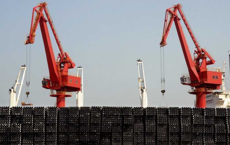 Piles of steel pipes to be exported are seen in front of cranes at a port in Lianyungang, Jiangsu province, March 7, 2015. u00e2u20acu201d Reuters pic