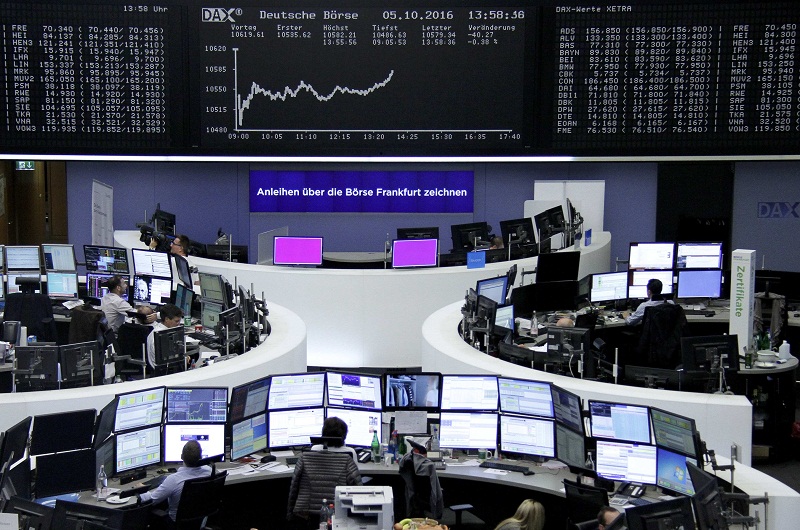 Traders work at their desks in front of the German share price index, DAX board, at the stock exchange in Frankfurt, Germany, October 6, 2016. u00e2u20acu201d Reuters pic