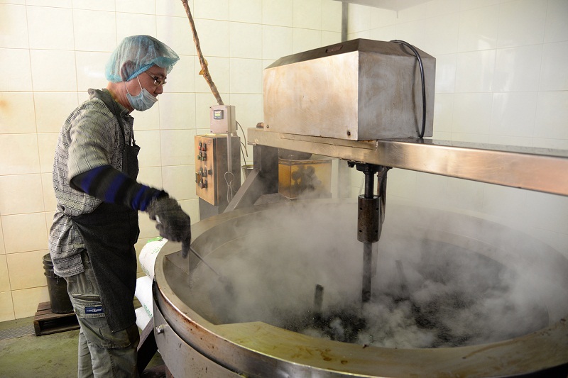 The other partner of the factory, Goh Bee Lye, checking on the coffee being cooked in sugar. —  Picture by K.E.Ooi