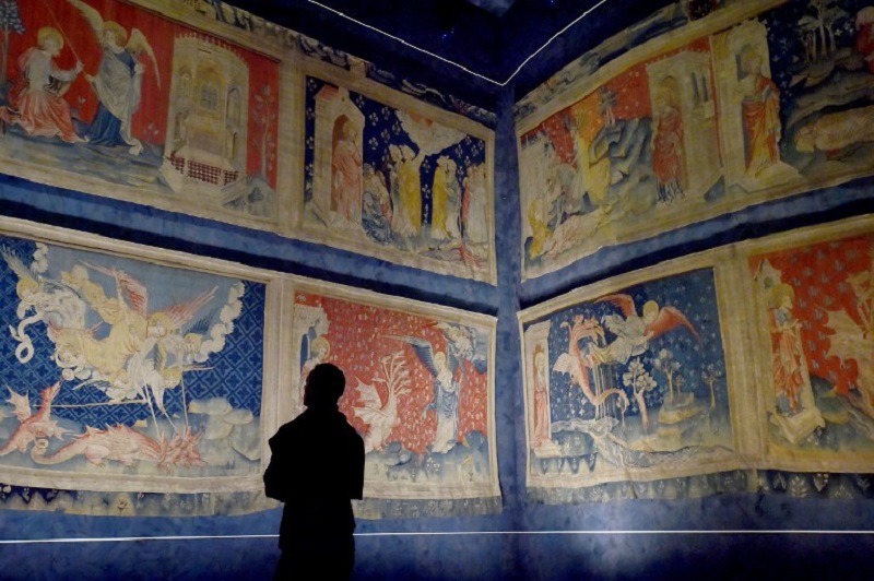 A visitor looks at the u00e2u20acu02dcApocalypse Tapestryu00e2u20acu2122 (1377u00e2u20acu201c1382), the worldu00e2u20acu2122s largest and oldest surviving medieval set of tapestries, at the Angers Castle in western France on September 22, 2016. u00e2u20acu201d AFP pic