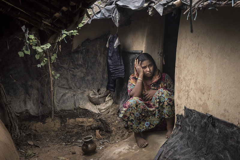 A Rogingya woman sits outside her home at the Kutupalong Refugee Camp in Teknaaf, Bangladesh, June 16, 2015.u00c2u00a0u00e2u20acu201d NYT pic
