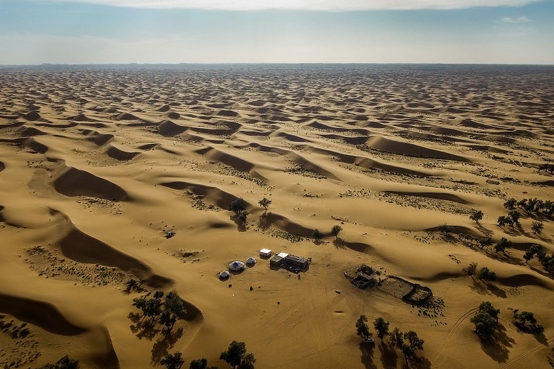 A view of the home of Du Jinpingu00e2u20acu2122s family, who lives on Swan Lake in the Tengger Desert in China, June 15, 2016. u00e2u20acu201d Picture by Josh Haner/The New York Times