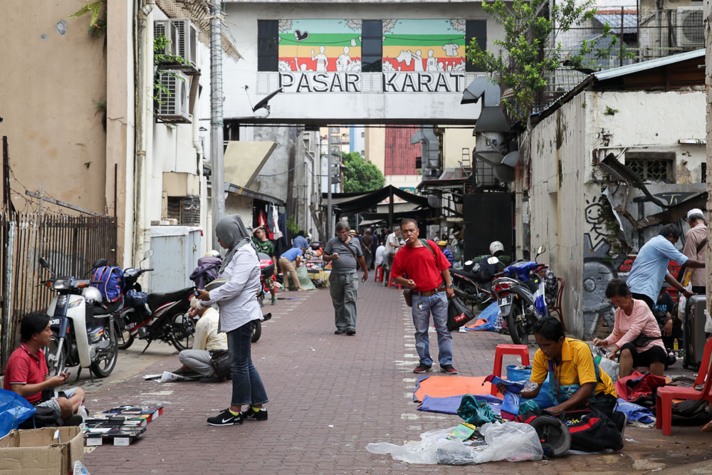 Traders selling counterfeit goods as potential customers look on.