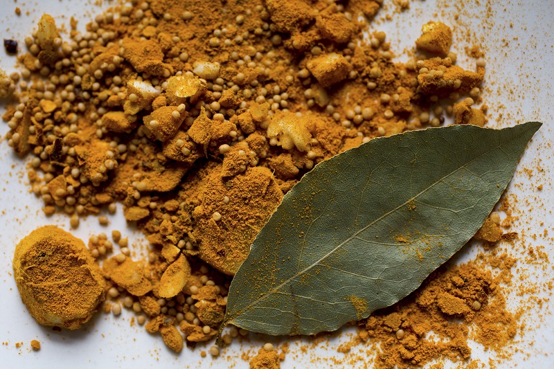 A mixture of garlic, ginger, mustard seed, turmeric, chilli flakes and a bay leaf, make up the seasoning for a recipe of green beans with mustard seeds, cashews and coconut, in New York, August 18, 2016. — Picture by Andrew Scrivani/The New York Times