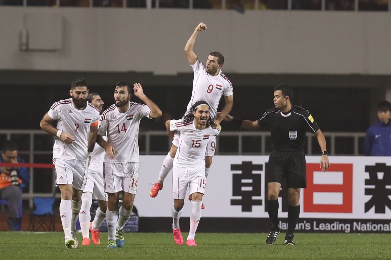 Syria's Mahmoud Al-Mawas and his team mates celebrate after scoring the first goal for Syria against China. u00e2u20acu2022 Reuters pic