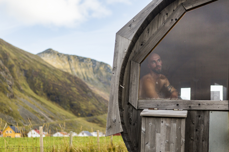 Surfer Mattias Hornquist watches fellow competitors on the waves through the window of a sauna after being knocked out of competition in the semifinals, on the beach in Unstad, Norway, October 8, 2016. — Picture by Leslye Davis/The New York Times