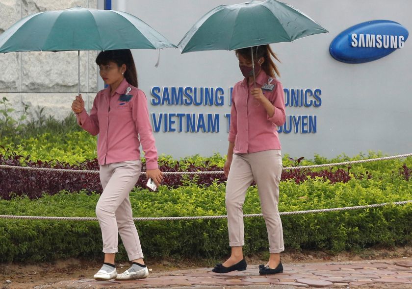 An employee holds a smartphone as she is on the way to work at the Samsung factory in Thai Nguyen province, north of Hanoi, Vietnam October 13, 2016. u00e2u20acu201d Reuters pic