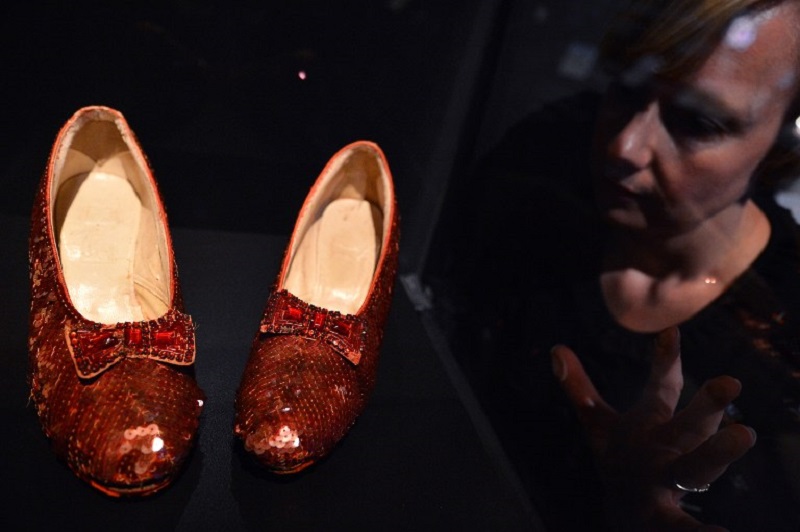 This file photo taken on October 17, 2012 shows a woman looking at the ruby slippers worn by Dorothy Gale (Judy Garland) in the 1939 movie u00e2u20acu02dcThe Wizard of Ozu00e2u20acu2122 displayed at the Hollywood Costume exhibition in the Victoria and Alebrt Museum in London. u00e2u20ac