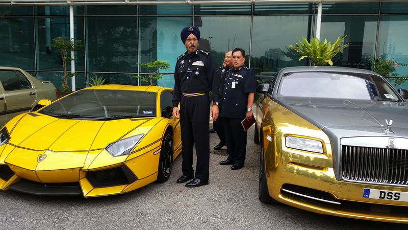 Kuala Lumpur police chief Commissioner Datuk Amar Singh Ishar Singh shows the two luxury cars worth RM3.4 million seized for investigations under the Customs Act October 19, 2016. u00e2u20acu201d Picture by Ida Lim n