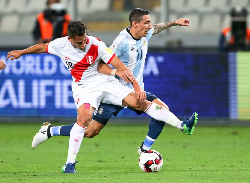 Argentina's Angel Di Maria (right) fights for the ball with Peru's Cristian Benavente. u00e2u20acu2022 Reuters pic