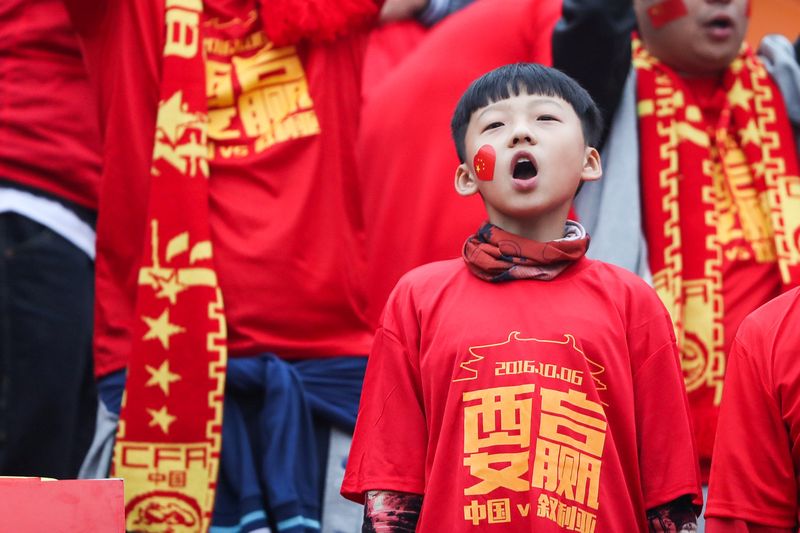 Chinese fans cheer ahead of World Cup qualifying match between China and Syria in Xi'an October 5, 2016. The Chinese characters read, 'We shall win.' u00e2u20acu201d Reuters pic