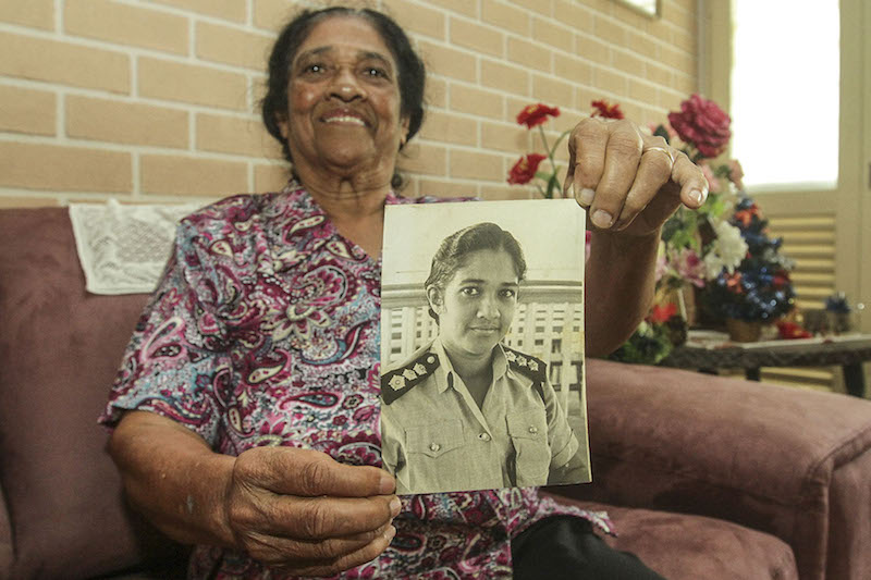 Koshy shows a photo of herself as a young police officer, also sharing that she used to play badminton and hockey for her school. — Picture by Yusof Mat Isa