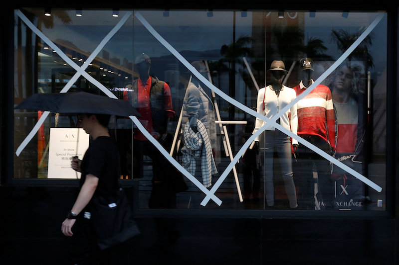 A man walks past a boutique with windows taped as Typhoon Haima approaches in Hong Kong, China, October 21, 2016. u00e2u20acu201d Reuters pic