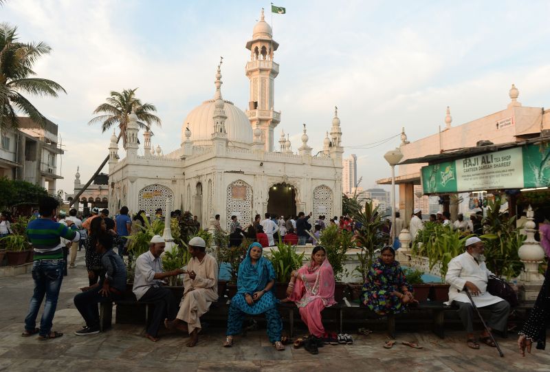In this photograph taken on December 9, 2015, Indian Muslims and visitors are seen at the Haji Ali Dargah in Mumbai. PUNIT PARANJPE / AFP