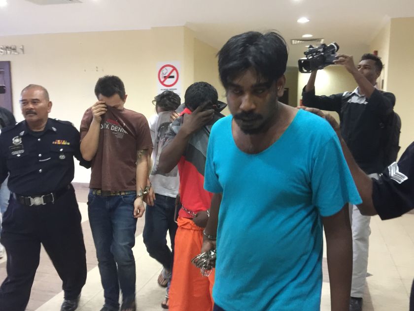 Police lead the five suspects out of the courtroom after they were charged with abduction and wrongful confinement for ransom. u00e2u20acu201dPicture by Opalyn Mok