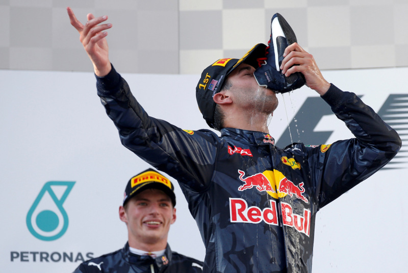 Red Bullu00e2u20acu2122s Daniel Ricciardo of Australia drinks from his shoe as he celebrates on the podium after winning the Formula One Malaysia Grand Prix in Sepang, October 2, 2016. u00e2u20acu201d Reuters pic