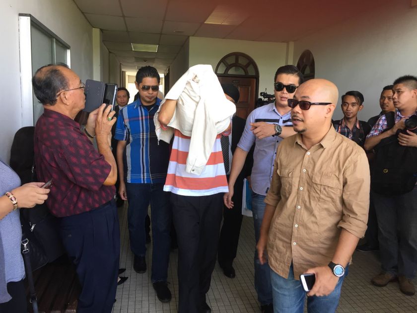 The former department deputy director (centre) who currently serves as the technical and engineering advisor to the state finance ministry, was released on bail pending investigations at the magistrate court. u00e2u20acu201d Picture by Julia Chan nn