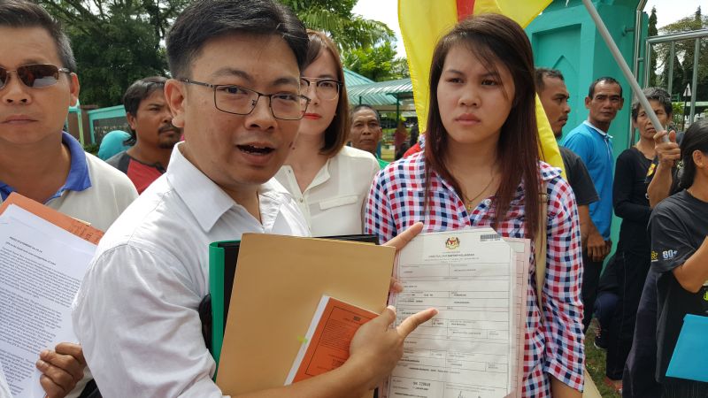 Human rights lawyer Simon Siah (left) with Rika Herline anak Ji-in (right) outside the Federal Government administrative building where the state NRD headquarters is housed, October 6, 2016. u00e2u20acu2022 Picture by Sulok Tawie
