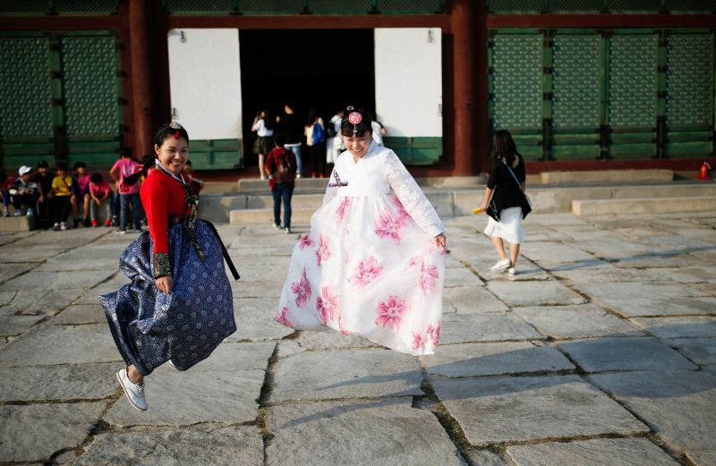 Tourists wearing Korean traditional costumes Hanbok jump as they pose for photographs at the Gyeongbok Palace in central Seoul, South Korea, October 8, 2016. u00e2u20acu2022 Reuters pic