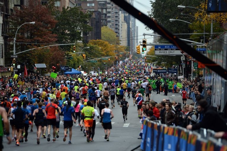 Participants run down the 1st Avenue during the TCS New York City 2015 Marathon. -- AFP pic