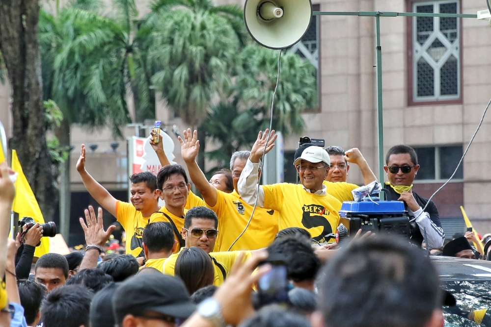 Former deputy prime minister Datuk Seri Muhyiddin Yassin (left) and former prime minister Mahathir Mohamad waving to the crowd at the Bersih 5 rally at KLCC November 19, 2016. u00e2u20acu201d Picture by Saw Siow Feng