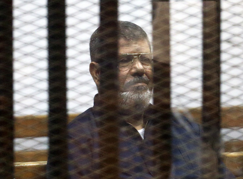 Deposed Egyptian President Mohamed Mursi listens to his verdict behind bars at a court on the outskirts of Cairo June 16, 2015. u00e2u20acu201d Reuters pic