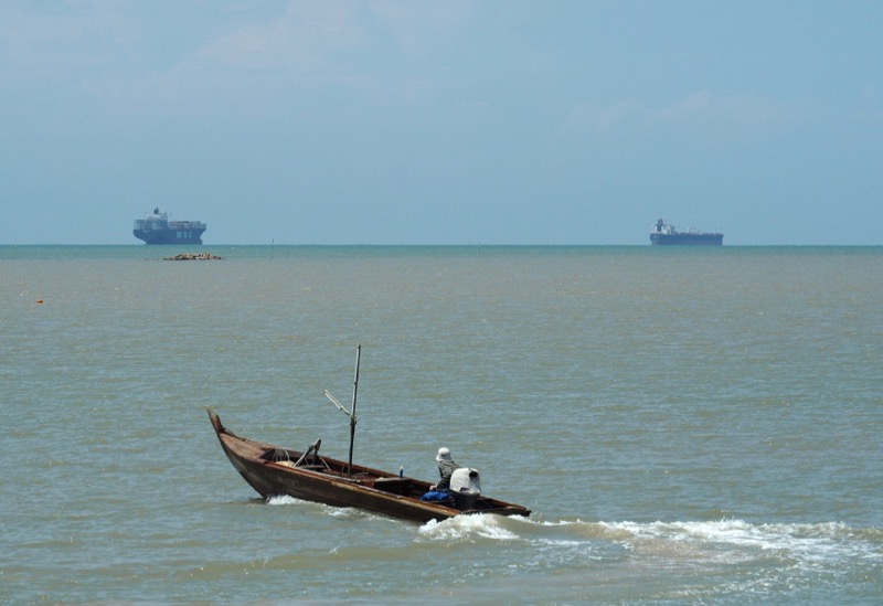 A fisherman drives his boat off the southern coast of Johor, Malaysia, as ships travel between the Singapore Strait and the Strait of Malacca November 12, 2016. u00e2u20acu201d Reuters pic