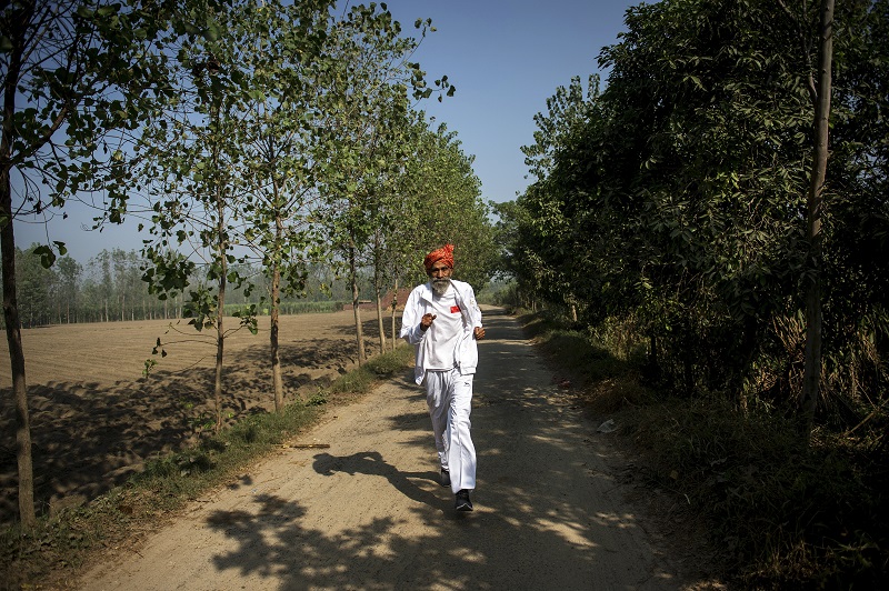 Dharam Pal Singh, a herder who regularly runs and claims to be 119-years-old, trains on a dirt road near his home in the village of Gudha, India, October 27, 2016. u00e2u20acu201d Picture by Vivek Singh/The New York Times