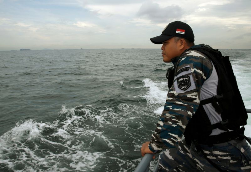 A navy personnel looks for survivors during a search and rescue operation after a boat carrying Indonesian migrants capsized off Batam on Wednesday, November 3, 2016. u00e2u20acu2022 Reuters pic