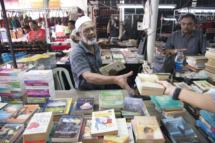 Shah Mohd Said sells second-hand books at reasonable prices at his stall. 