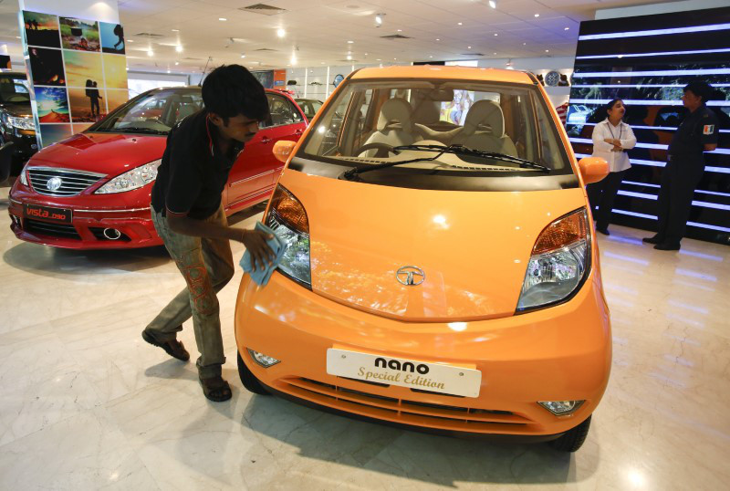A showroom attendant cleans a Tata Nano car at their flagship showroom in Mumbai May 28, 2013. — Reuters pic