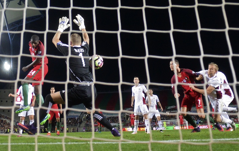 Portugal's midfielder William Carvalho (left) heads the ball to score during the WC 2018 qualifying football match Portugal vs Latvia at the Algarve stadium in Faro on November 13, 2016. u00e2u20acu201d AFP pic